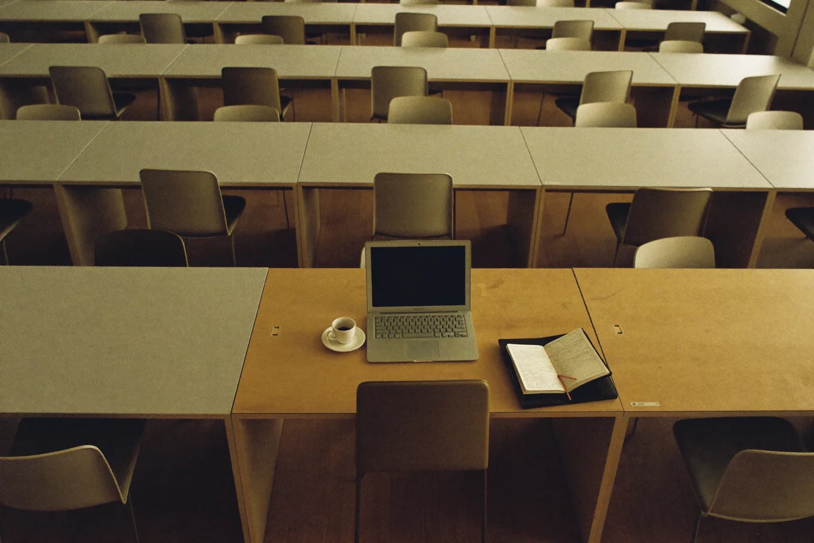 A single desk in a large, mostly empty open-plan office, seen from above.